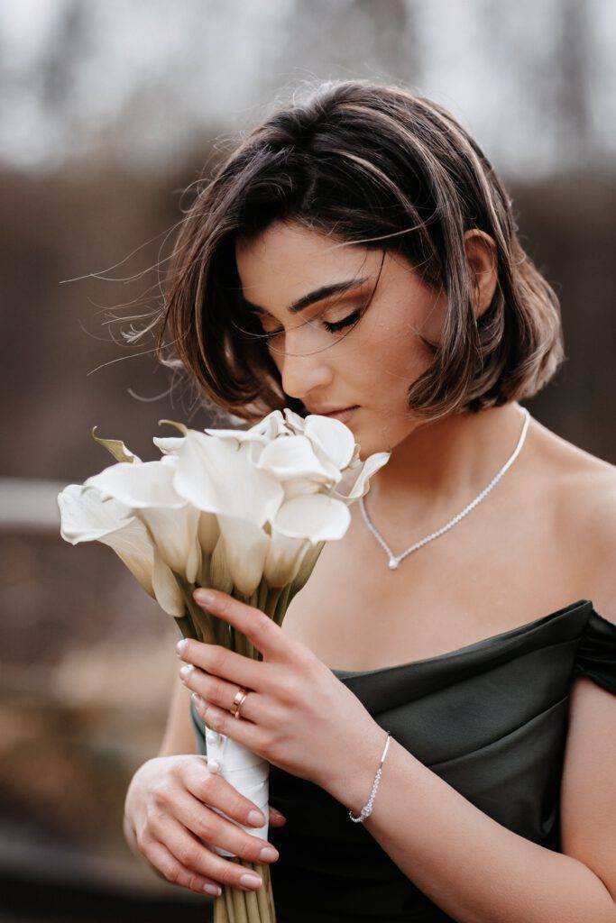 Die Braut hat Tulpen in der Hand, an denen sie riecht und die Augen geschlossen hat. Hochzeitsfotograf Hamburg. Hochzeitsfilm Hamburg